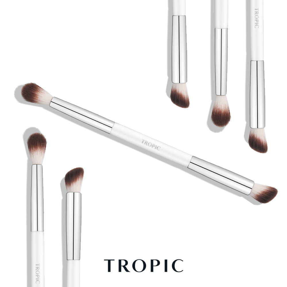 A set of white and silver Tropic makeup brushes arranged on a clean white background, with the brand name TROPIC printed on the handles and shown again at the bottom.
